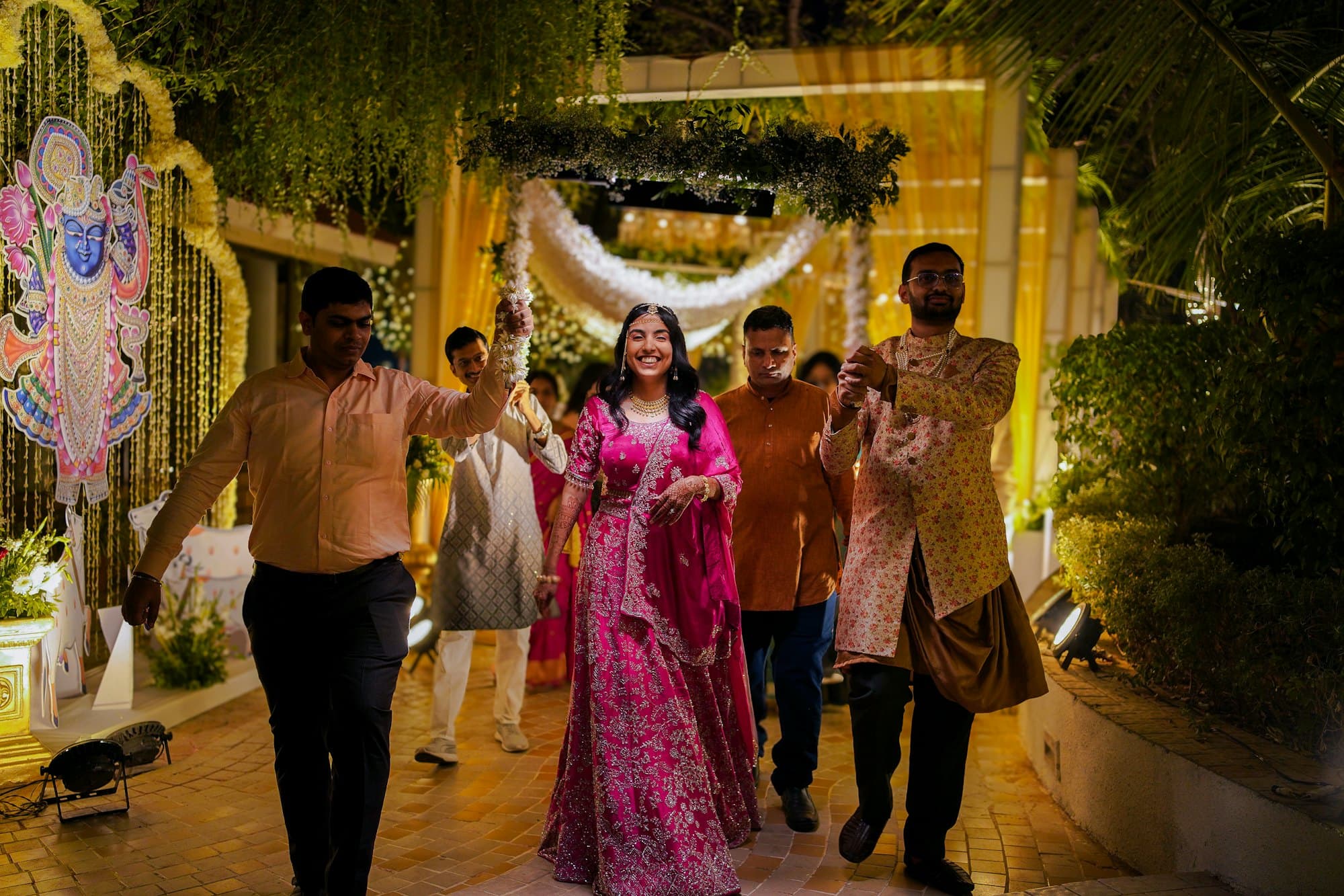 Guests joyfully escorting a bride at an evening wedding