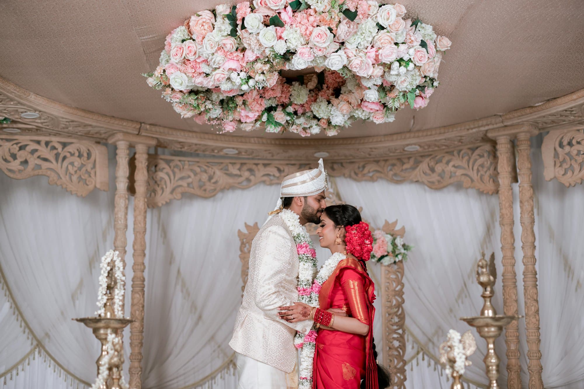 A bride and groom in traditional Indian wedding attire