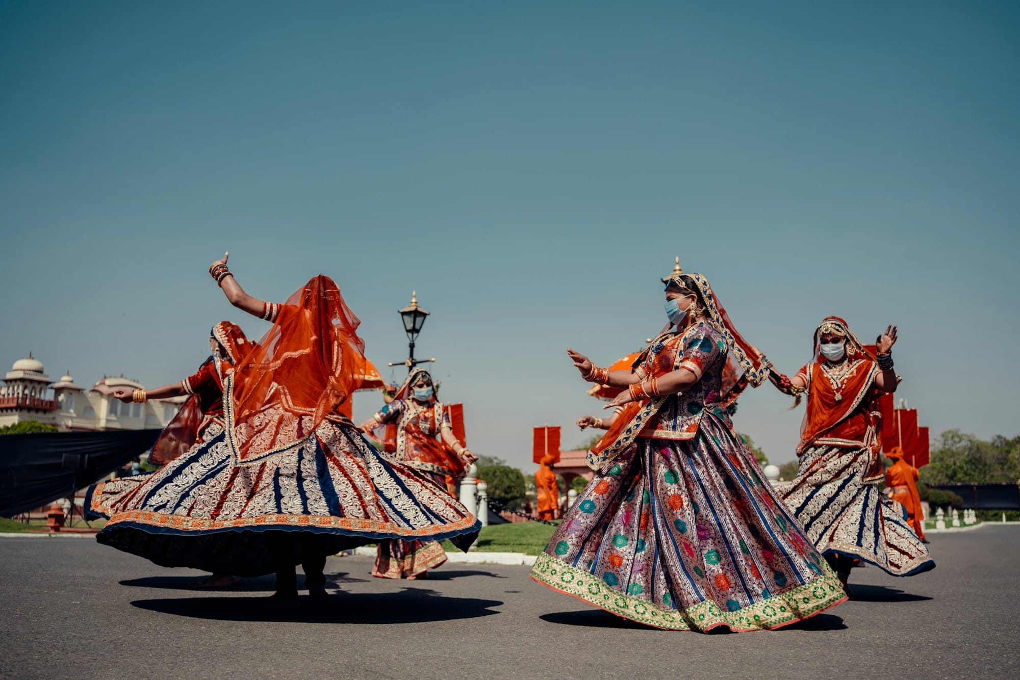 A group in traditional dress performing together outdoors